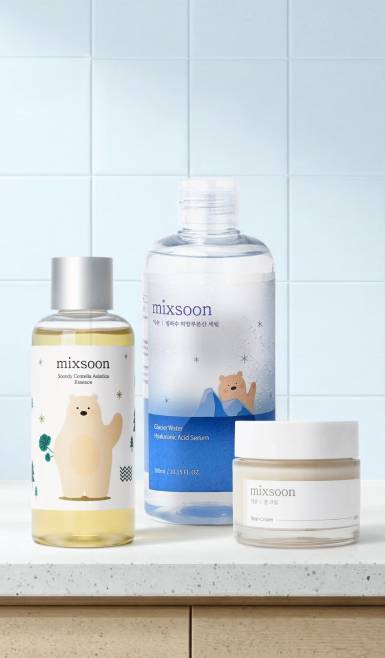 Variety of mixsoon products are on a counter—a bottle of Soondy Centella Asiatica Essence, a bottle of hyaluronic acid serum and a jar of Bean Cream.