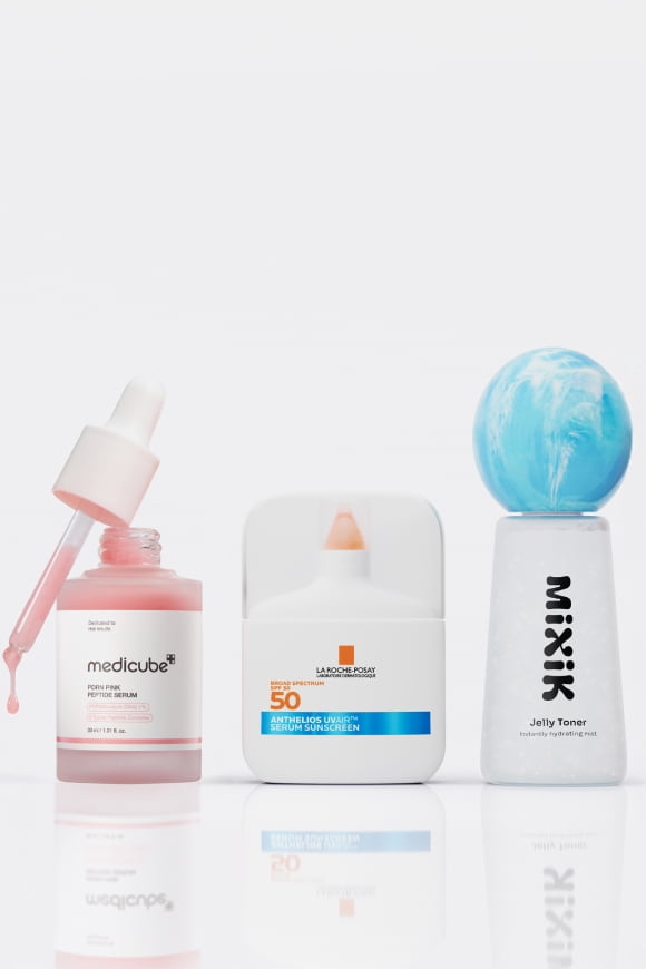 Medicube serum, La Roche Posay SPF 50 sunscreen and Mixx Jelly Toner bottles stand in a row.