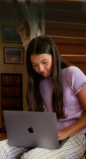 Image of a woman working on a McBook. Apple: magic runs in the family. Shop now.