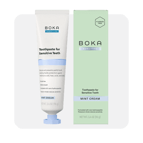 Image shows Boka Fluoride-Free Sensitive Toothpaste in mint cream flavor next to its green packaging, with a white background.