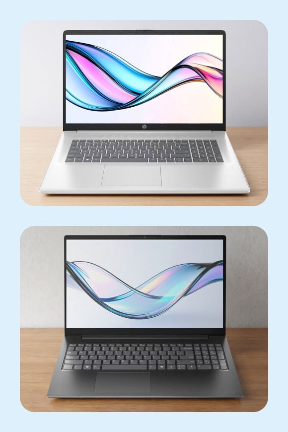 Two slim laptops on a wooden surface, one silver and one dark gray, both open with colorful abstract wave designs on their screens.