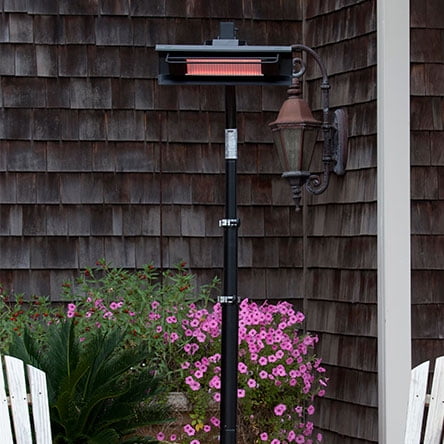 A black electric patio heater in a backyard. Links to the best electric patio heaters on Walmart.com.