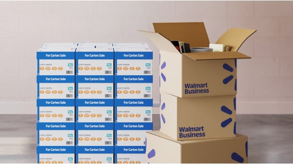 Walmart Business boxes next to stacks of copy paper.