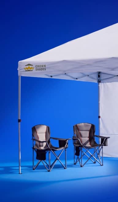 Crown Shades canopy tent with two folding camping chairs underneath.