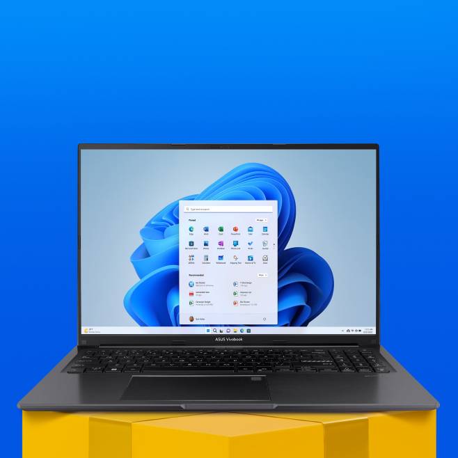 A black ASUS Vivo Book laptop is open with a colorful display on top of a gift podium.