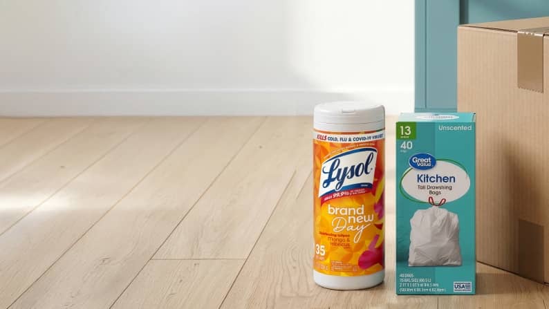 Lysol disinfectant wipes and Great Value trash bags are shown alongside a moving box.