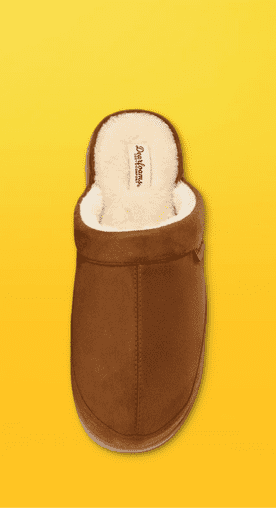 Image shows a brown Dearfoams men's scuff slipper with a cozy white interior on a yellow background.