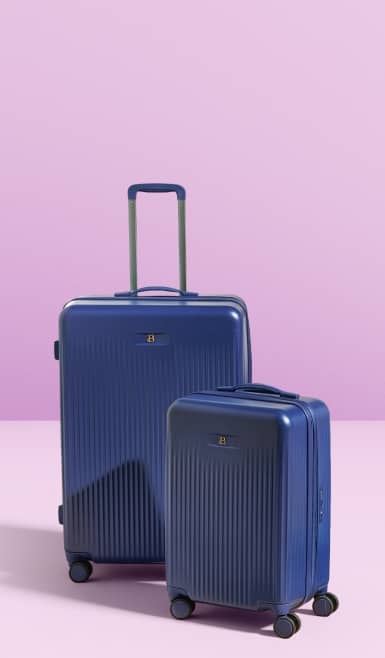 Two blue hard-shell rolling suitcases in different sizes standing upright against a soft pastel background.