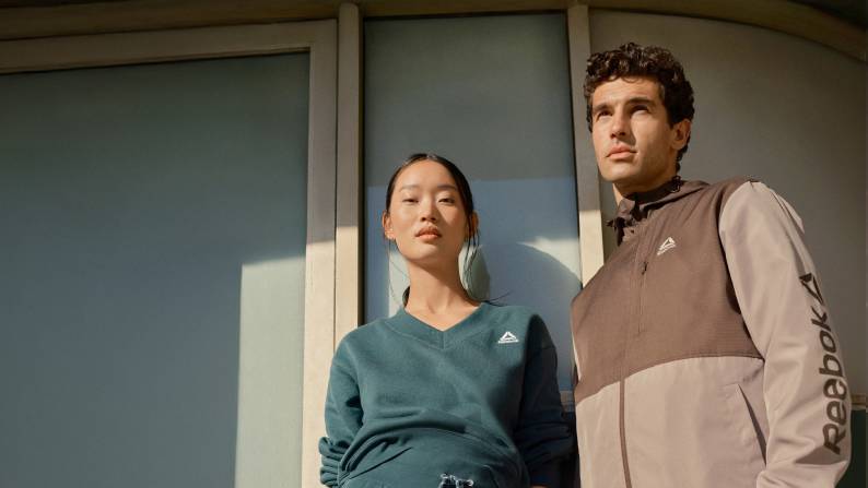 A young adult woman and man are shown wearing workout clothes.