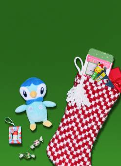 View a Pokémon toy as well as various candies stuffed into a chevron red and white stocking.
