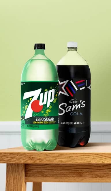 2 two-liter bottles of soda are shown on a kitchen counter.