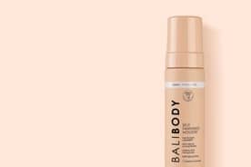 Self-tanner on a light pink background.