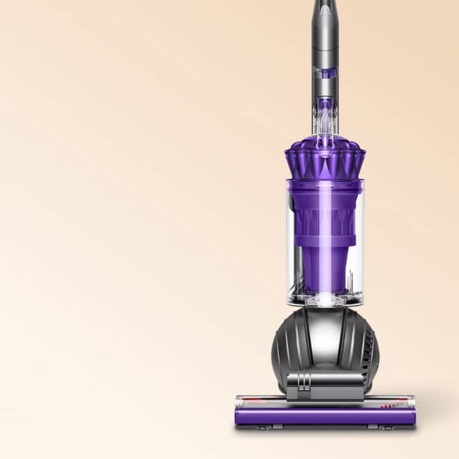 Purple upright vacuum cleaner with clear canister and spherical base on a plain background.