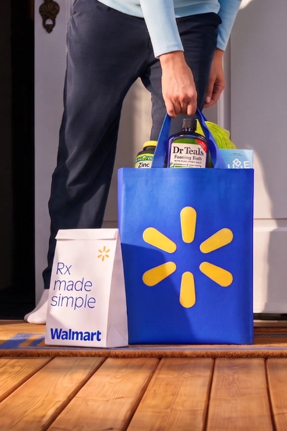 Rx made simple Walmart pharmacy paper bag and blue Walmart tote with Dr Teals and health products on a porch held by an adult.