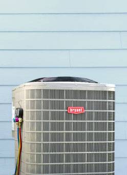 A close-up image of a Bryant HVAC unit on the exterior of a home.