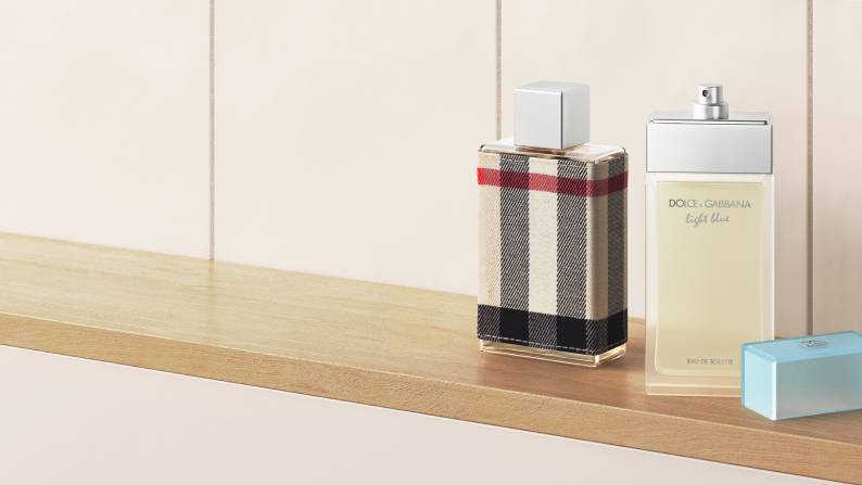 A lifestyle shot of three perfumes lined up on a shelf.