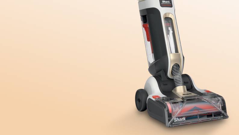 Shark upright vacuum cleaner with clear dust canister and brush head.