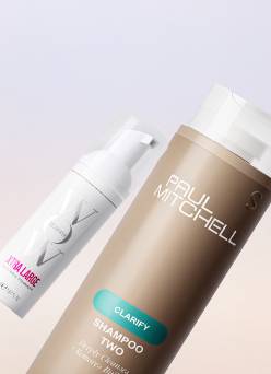 An image of a Color Wow hair product and a Paul Mitchell shampoo shot against a lavender and beige gradient background.