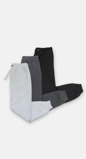 A trio of cozy sweatpants crisply folded.