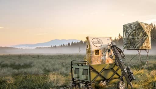Deer corn in a wagon on a field.