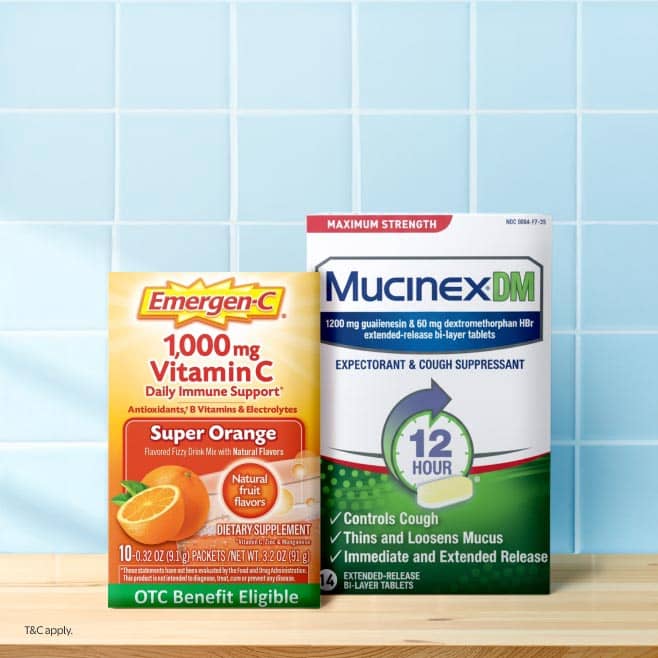 Image shows a box of Emergen-C Daily Immune Support & a box of Mucinex DM cough suppressant on a countertop.