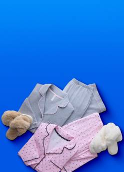 Girls matching P J sets in gray and pink with black dots are next to brown and white pairs of fuzzy slippers.
