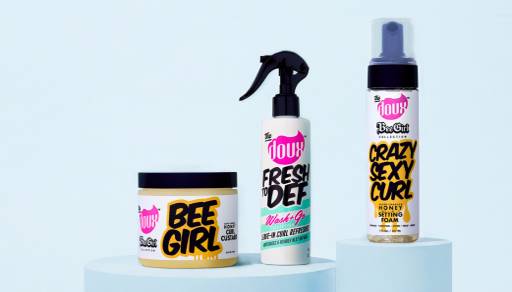 Three of The Doux hair products are shown—including Bee Girl Honey Curl Custard, Fresh to Def Curl Refresher and a Crazy Sexy Gurl Honey Setting Foam.