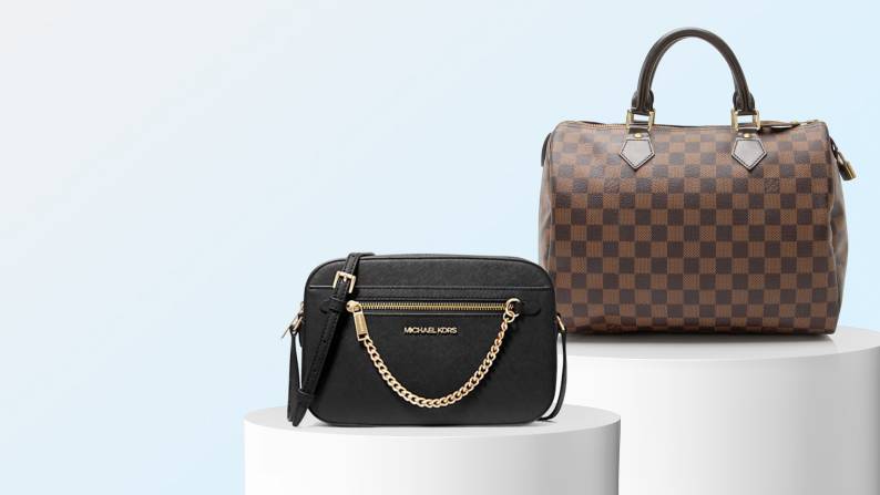 A Michael Kors bag and a Louis Vuitton bag are on white risers.