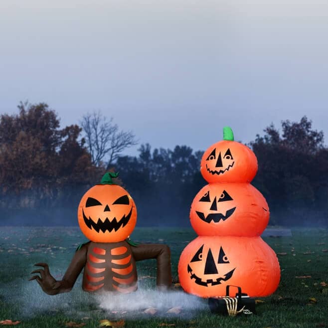 Inflatables of a pumpkin skeleton figure and stacked pumpkins.