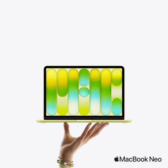Hand holding up a Citrus MacBook Neo.
