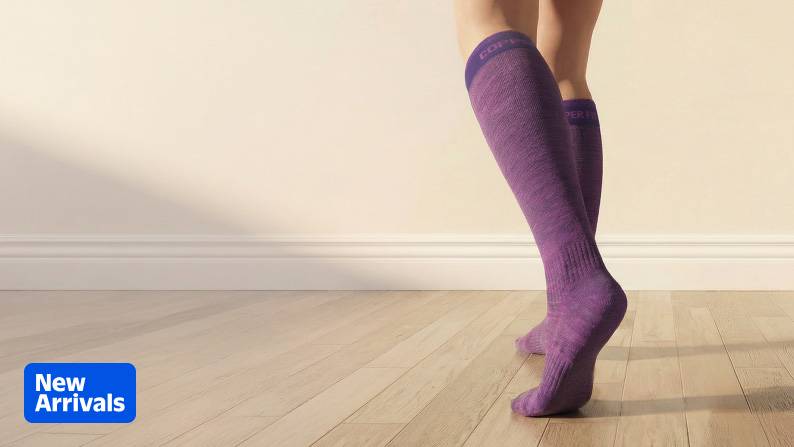 Person wearing purple compression socks.