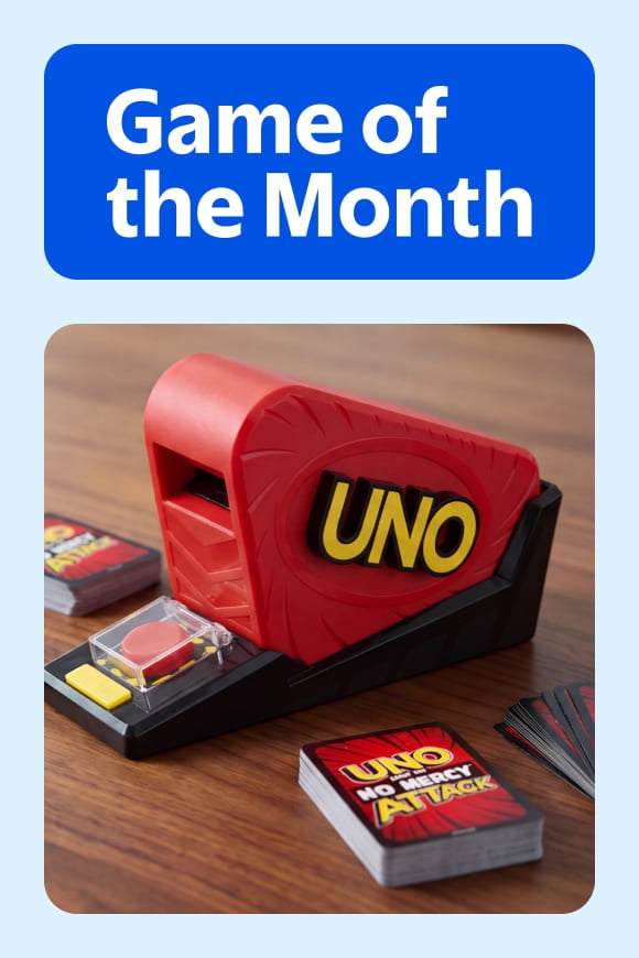 Game of the Month badge with Uno No Mercy Attack card shooter and card decks on a tabletop.
