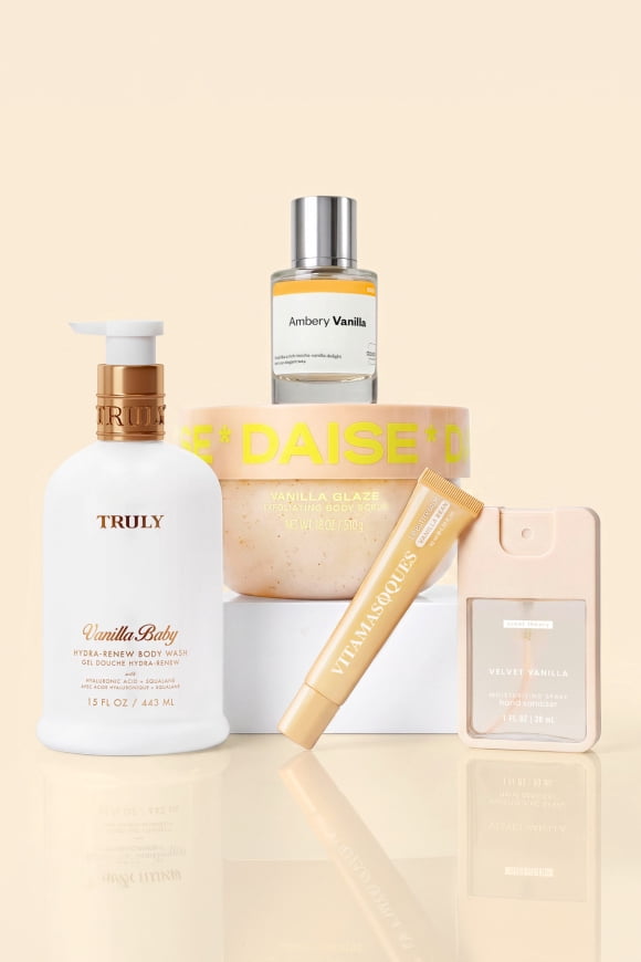 Truly Vanilla Body lotion, Amberoy Vanilla fragrance, Daisey body cream, Vitamasques stick and a pale spray bottle arranged together.