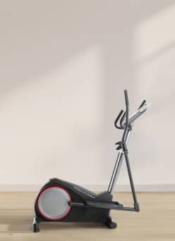 An image of an elliptical machine in a beige room with light wood floors.