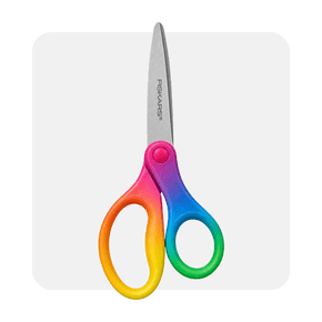 Image shows a pair of Fiskars scissors with rainbow-colored handles and a gray blade on a white background.