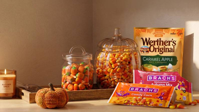Jars of orange candy are shown, next to a bag of Whether’s caramels and Brachs candy corn and candy pumpkins.