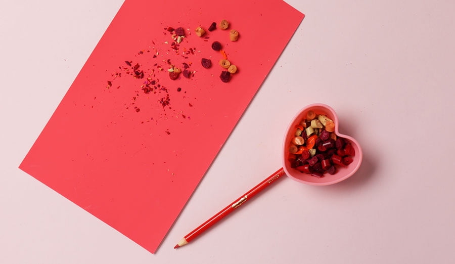 crayon pieces added to baking cup covering pencil