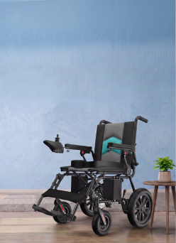 Electric wheelchair with joystick control beside a small wooden table holding a potted plant.