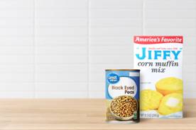 A box of JIFFY cornbread and a can of Great Value black eyed peas is shown.