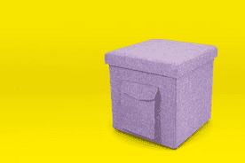 Image shows a heathered purple Humble Crew folding storage ottoman with a pocket on a yellow background.