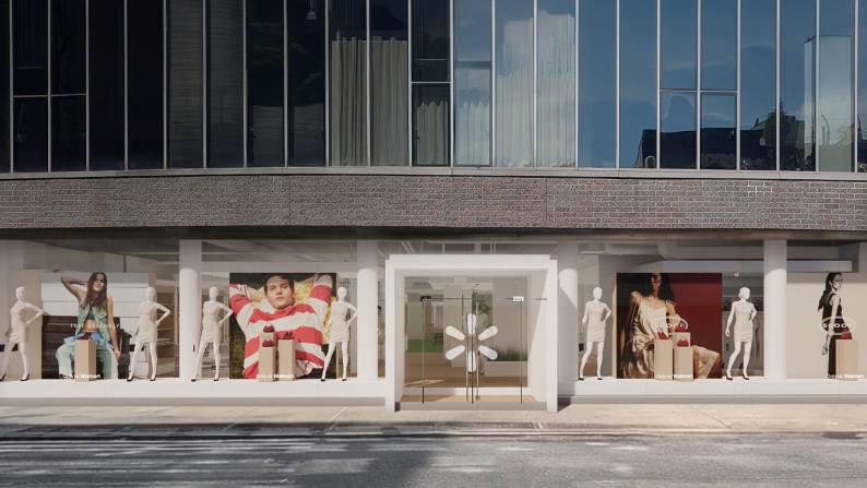 The exterior of the Walmart pop-up with large windows has mannequins in front of images from the latest Scoop and Free Assembly campaigns inside.