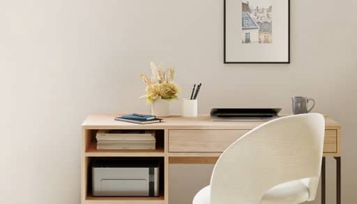 A small home office with a desk, chair & accessories neatly assembled.