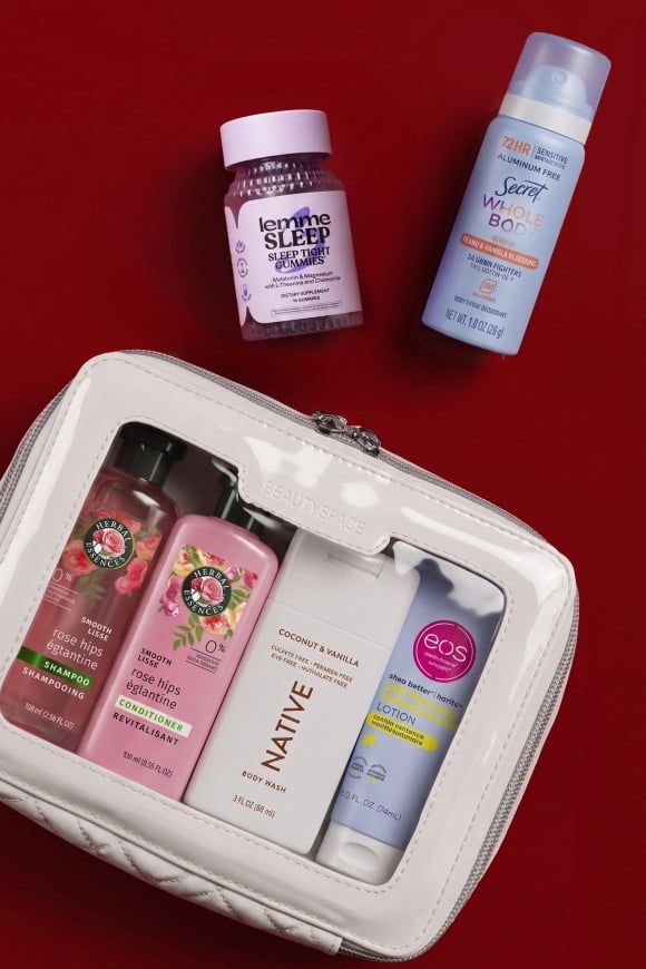 Lemme Sleep gummies, Secret Weightless Dry Spray and a clear toiletry bag with assorted travel size shampoo, lotion and body wash.