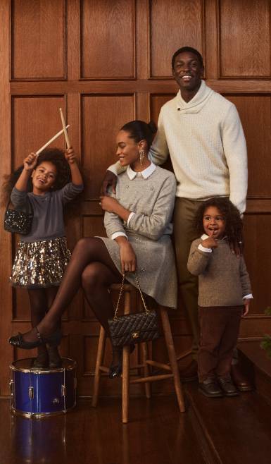 From ten dollars. A family of four dressed in holiday looks is pictured in front of a wood panel backdrop.