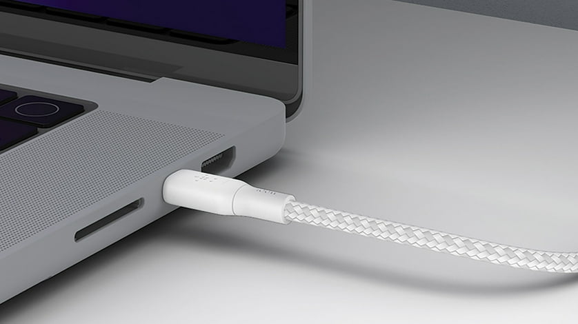 Belkin electronic charging cable inserted into a computer.