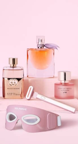 Assorted bottles of perfume, Solawave mask and Solawave wand.