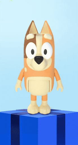 Image shows a multicolored Bluey action figure on a blue gift box with a light blue background.