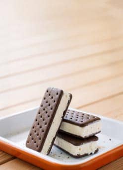 A stack of ice cream sandwiches in a casserole dish on a deck.