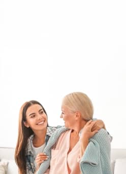 A caregiver assisting an elderly woman.
