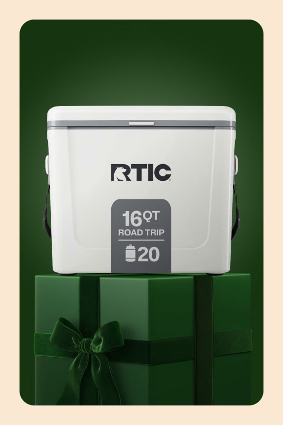 RTIC cooler reads: 16QT Road Trip 20, displayed on a green gift box with ribbon.